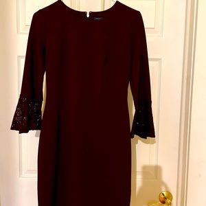 Elegant eggplant color dress with lace flare at elbow